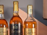 three bottles of wine sitting on a table next to each other