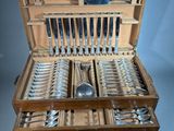 a wooden case with silverware in it on a table