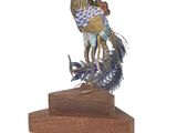 a statue of a bird on a wooden base