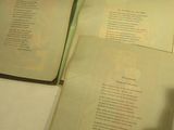 two open books sitting on a table next to each other