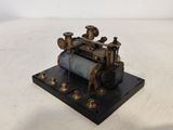 an old model of a steam engine sitting on top of a table