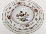 three plates with floral designs are stacked on top of each other