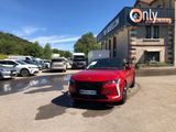 a red car is parked in front of a building with a sign that says on it