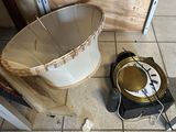 a clock that is sitting on the floor next to a bucket