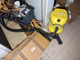 a yellow blower sitting on the floor next to a pile of boxes