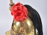an image of a helmet with a red feather on top of it