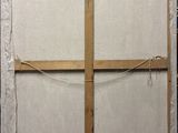 painting of a cross made of wood with a piece of paper taped around it
