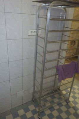 a towel rack in the corner of a bathroom