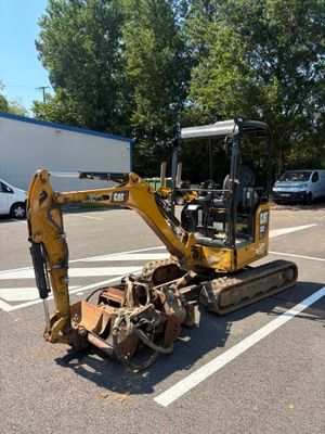 a small bulldozer that is parked in a parking lot