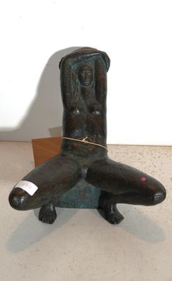 a statue of a man sitting on top of a chair