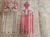 a red and white rug with a design on it