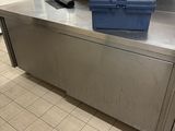 a metal counter with a blue toolbox on top of it