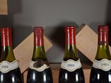 four bottles of wine are lined up in a row on a table