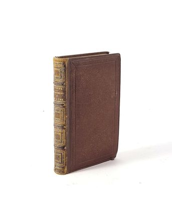 an old book sitting on top of a table next to a white background