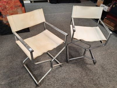 pair of chrome and leather folding chairs on carpeted floor