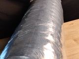 a roll of plastic sitting on a table next to a knife
