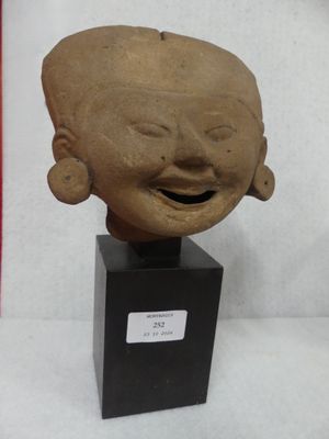 an image of a clay head of a person with a smile on it