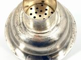 a small metal object that is sitting on a white surface
