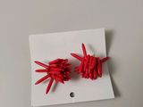 two pieces of red plastic that are on a piece of paper