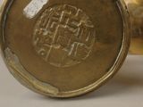a close up of a gold vase with a design on it