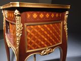 a small table with a drawer on top of it