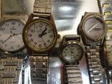 a lot of watches that are sitting on a table