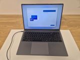 a laptop computer sitting on top of a table