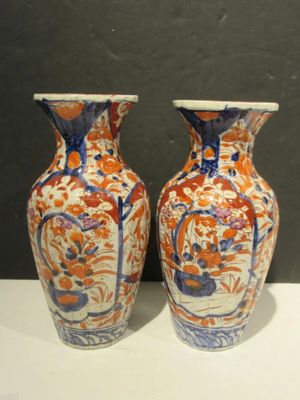 two vases that are sitting on a table
