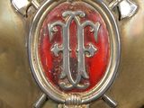 a gold helmet with a red and black emblem on it