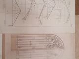 two drawings of a boat on a table next to a book