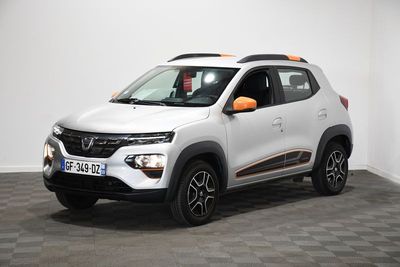 La voiture blanche et orange est garée dans une pièce blanche.