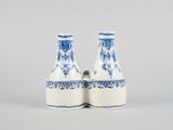 pair of blue and white vases sitting on top of each other