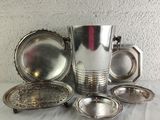 a lot of silver items sitting on a table