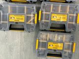 three yellow and black tool boxes sitting on top of a wooden floor