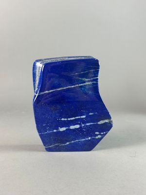 a close up of a blue stone on a white surface