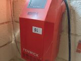 a red fire extinguisor attached to a brick wall