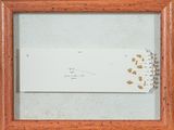 une photo encadrée représentant un bout de papier sur lequel figurent des inscriptions