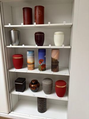 many different vases on the shelves in this cabinet