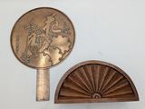 a small fan and a small mirror on the wall