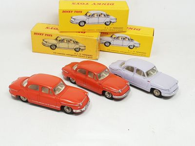 several toy cars are lined up in a row on a white surface