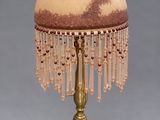 an image of a table lamp with a glass shade and beaded lampshade