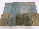 several old books sitting on top of each other on a table