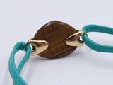 turquoise cord bracelet with a wooden disc on a gold plated clasp