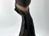 a black sculpture of a person with a hat on it ' s head