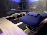two massage beds in a room with a painting on the wall