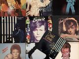 many different album covers on the table together