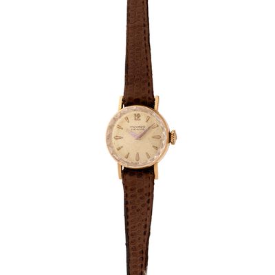 a close up of a watch on a white background with a brown strap