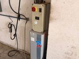 a water heater that is attached to a wall in a garage