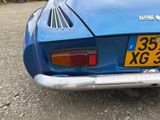 a blue sports car parked on the side of the road
