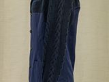 a mannequin wearing a blue sweater and black jacket